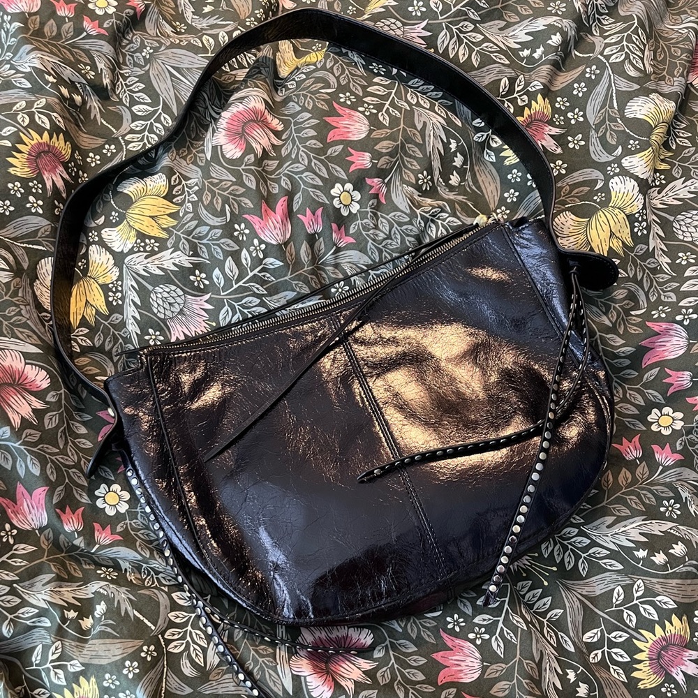 Hobo sling purse. Black leather. Studded tassels. Barely used, no visible wear.